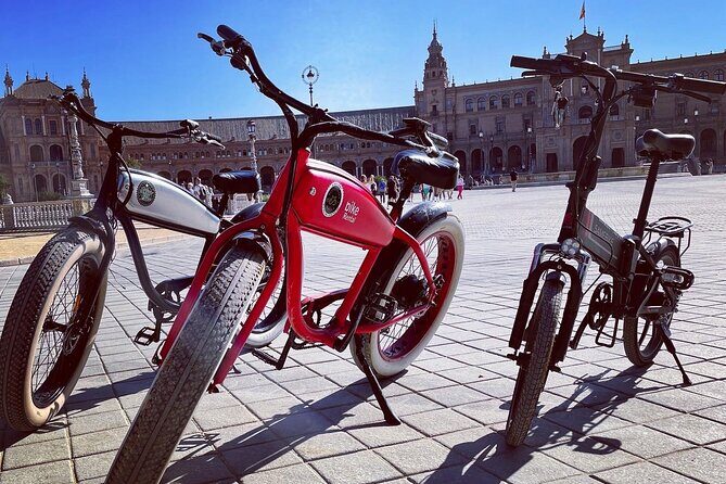 Ride Seville by E‐Bike – Small Group Local Experience - Triana river views: bridge, market, and the bullring quick stop
