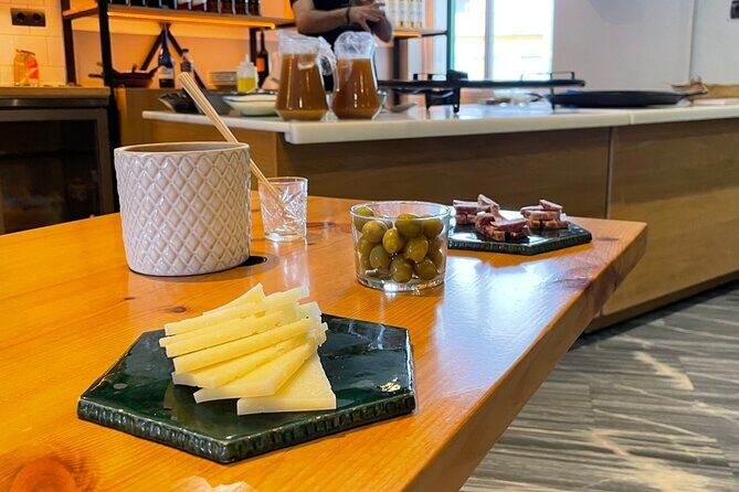 Seville: Paella Showcooking Experience - Starters and drinks: cheese, olives, Iberian salchichón, then sangria